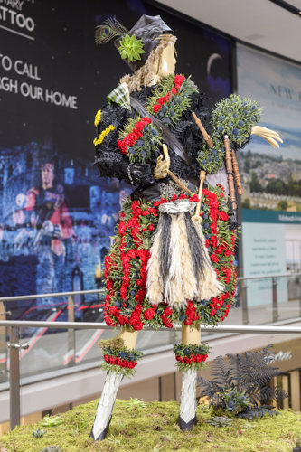 Floral mannequin of Edinburgh Tattoo's first serving female Lone Piper at Fleurs De Villes FEMMES exhibition 2022